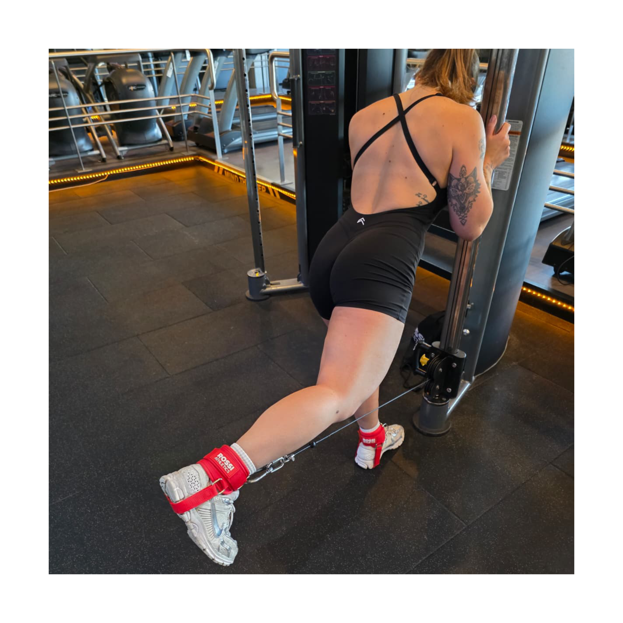 Rossi Athletics ankle strap attached to cable machine for glute exercise