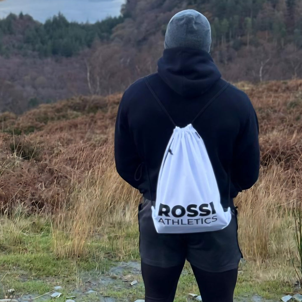 Rossi Athletics white drawstring gym bag worn outdoors